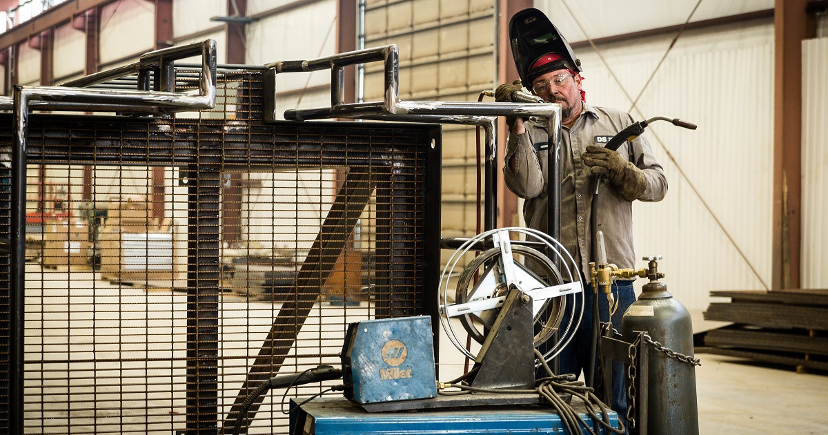 Welder wears protective gear at work