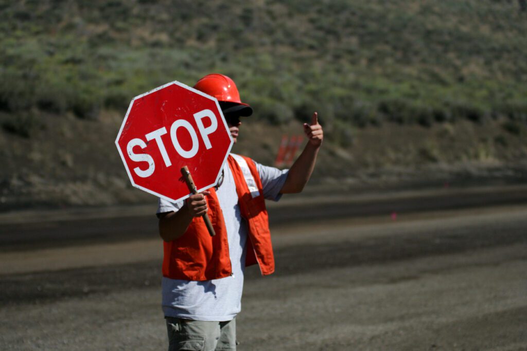 Construction worker holding a stop sign