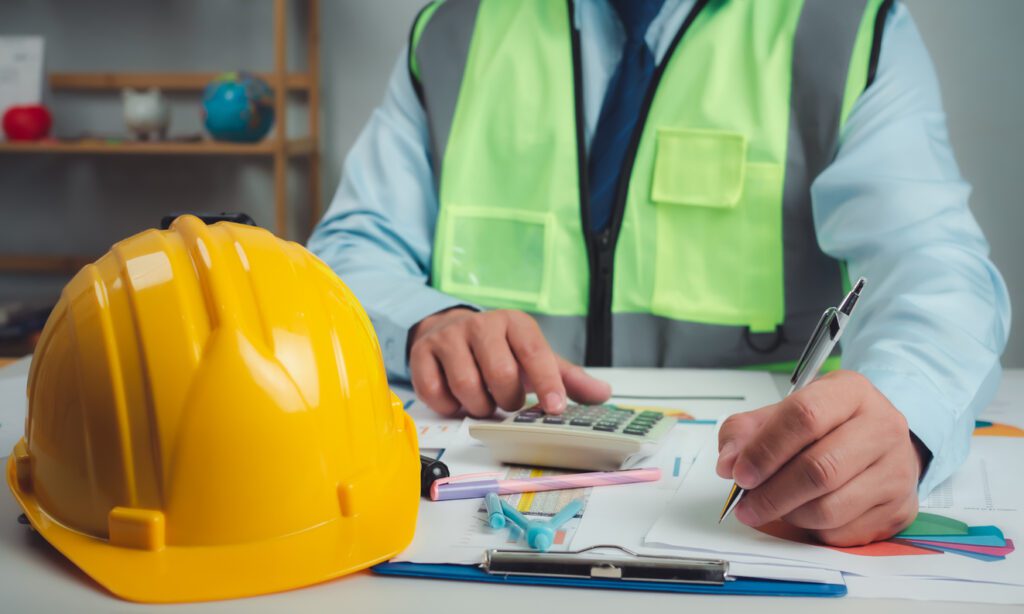 Architect or engineer sitting at desk in office, Cost calculation, Construction planning, structural calculation, Project construction cost planning and calculation, Project presentation plan.