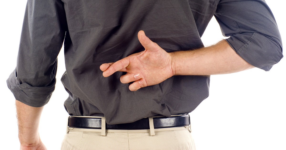 Man crosses fingers behind back
