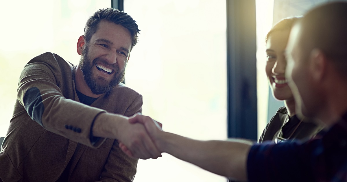 Men in business casual attire shake hands